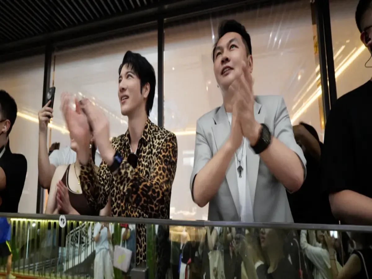 Wang Leehom and Crostars Chairman Shi Zheyuan applauding while watching drone light show performance at Shanghai Yangpu waterfront