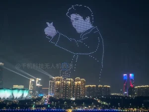 Crostars 1,000 drones forming Leehom Wang figure holding microphone above Hangzhou skyline