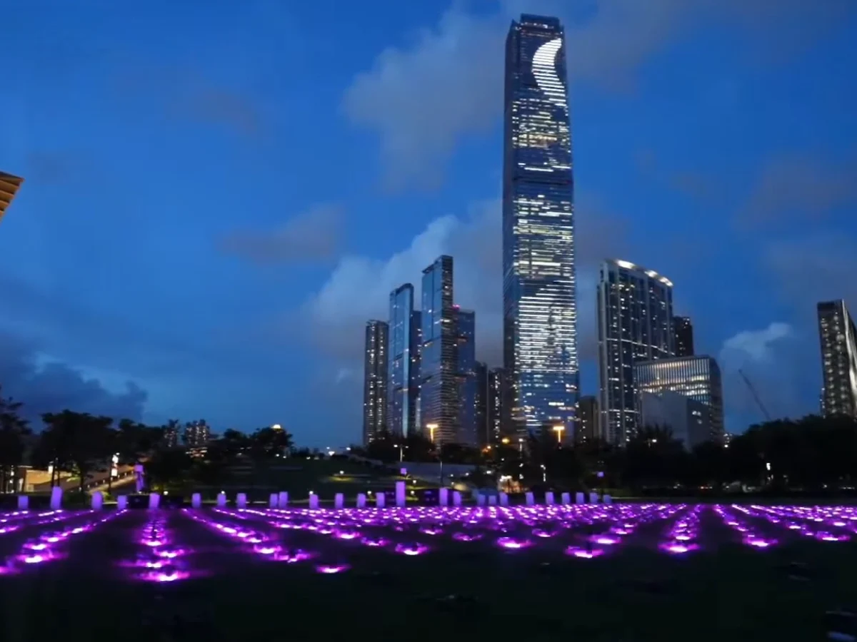 Crostars drones arranged on ground awaiting takeoff against Hong Kong ICC tower skyline for Bauhinia Night light show, 2023