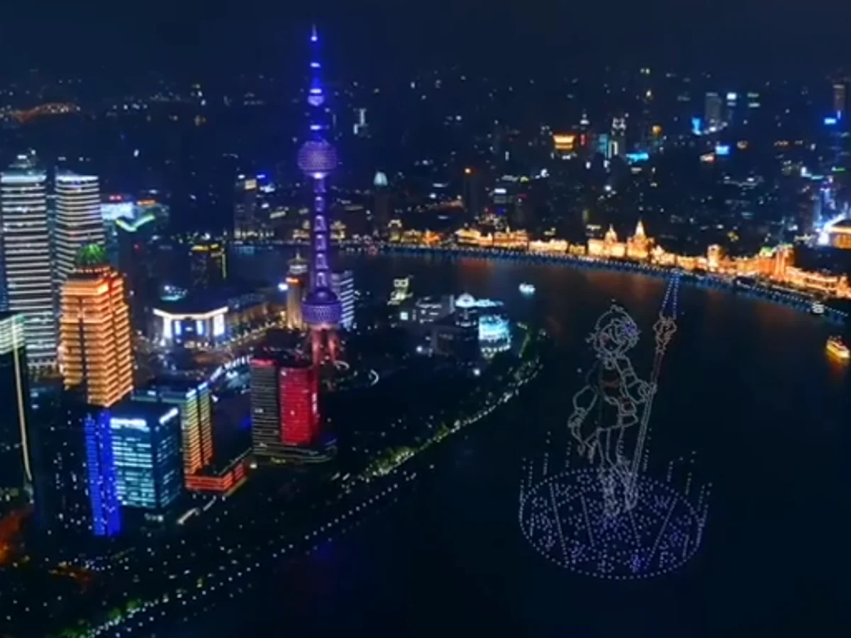 Crostars drones forming Princess Connect ReDive character above Shanghai Oriental Pearl Tower and Huangpu River