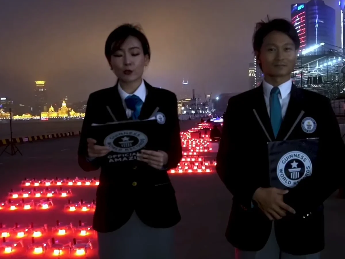 Guinness World Records officials presenting certificate to Crostars for 3,281 drone world record, Shanghai Bund, 2021