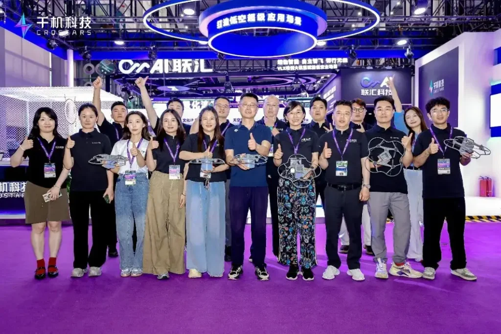 Crostars team holding C5 drones at their Drone World Congress 2026 exhibition booth in Shenzhen
