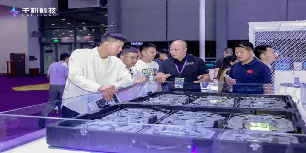 Crostars sales representative presenting boxed C5 drone array to visitors at Drone World Congress 2026